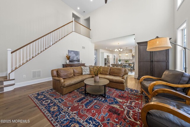 61 Windermere Rd, Lincroft, NJ 07738 - living room with visible vents, a chandelier, baseboards, wood finished floors, and stairway