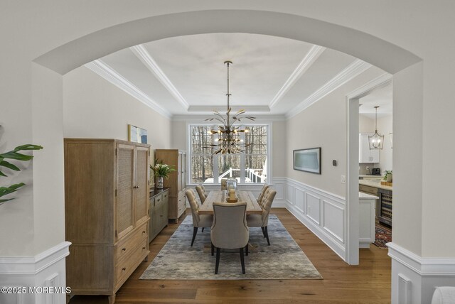 61 Windermere Rd, Lincroft, NJ 07738 - dining space featuring a tray ceiling, arched walkways, dark wood finished floors, and a chandelier