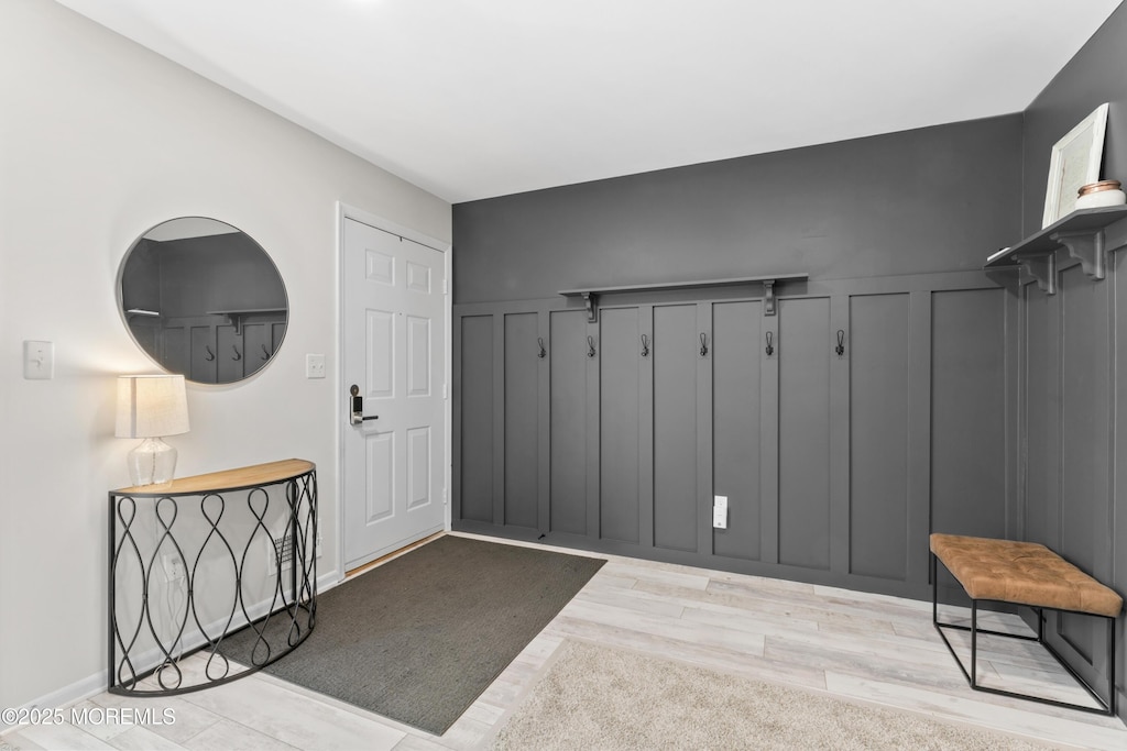 4107 Birchwood Ct, North Brunswick, NJ 08902 - interior space with wainscoting, a decorative wall, and light wood-type flooring