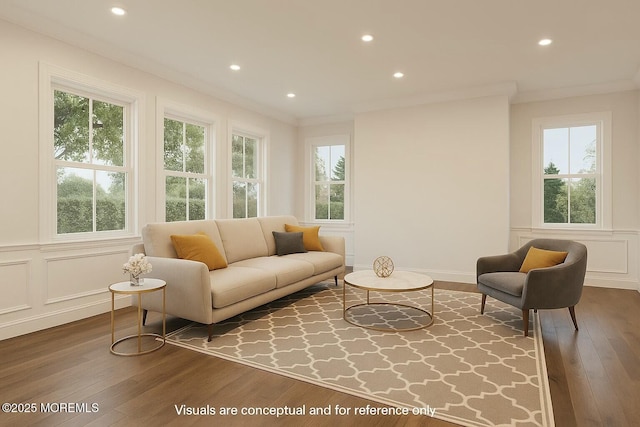 living area featuring dark wood-style flooring, recessed lighting, ornamental molding, and a decorative wall