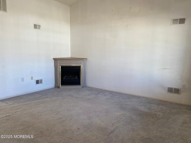 1042A Canterbury Dr, Manchester, NJ 08759 - unfurnished living room with visible vents, carpet floors, and a fireplace