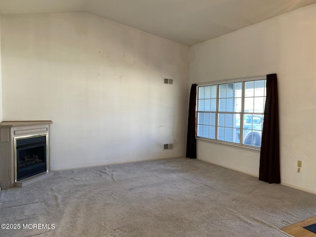 1042A Canterbury Dr, Manchester, NJ 08759 - unfurnished living room featuring carpet floors, visible vents, and vaulted ceiling