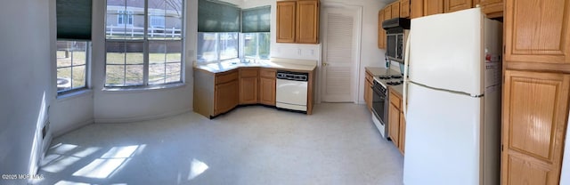 1042A Canterbury Dr, Manchester, NJ 08759 - kitchen with light countertops, a sink, exhaust hood, baseboards, and white appliances
