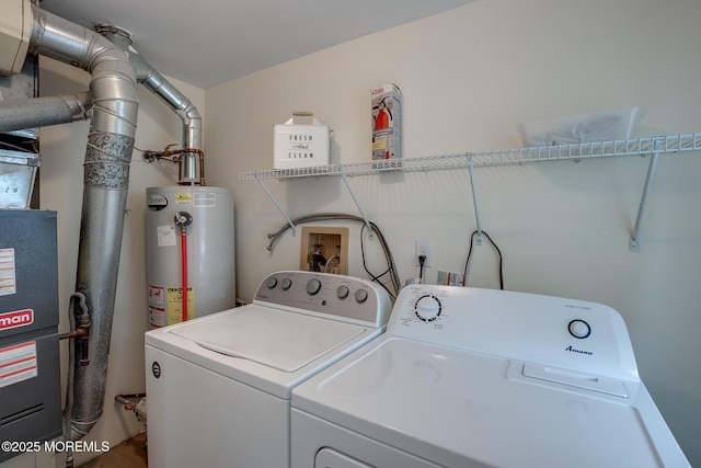 laundry room featuring washing machine and dryer, laundry area, and gas water heater
