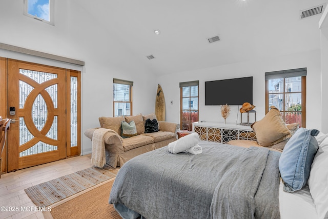 bedroom with light wood-style floors, multiple windows, and visible vents