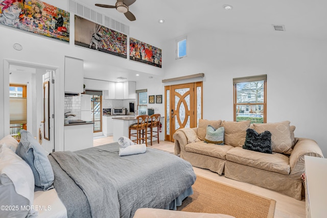 living area featuring recessed lighting, a toaster, a high ceiling, visible vents, and a ceiling fan