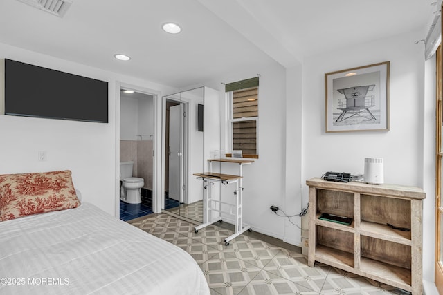 bedroom with recessed lighting, baseboards, ensuite bath, and visible vents