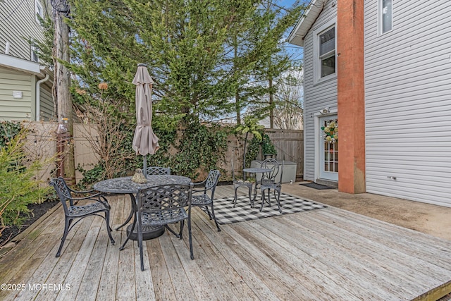 wooden deck with fence and outdoor dining space