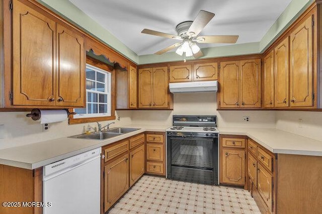 kitchen featuring a sink, white dishwasher, brown cabinetry, under cabinet range hood, and black gas stove