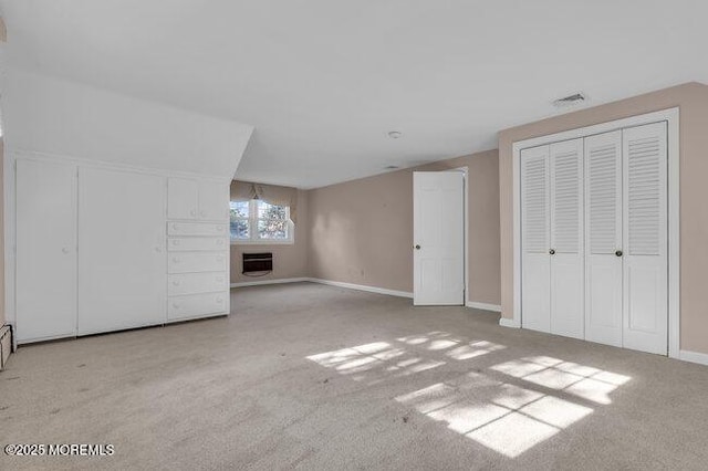 bonus room with baseboards, carpet floors, a fireplace, and heating unit