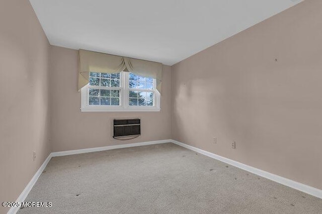 unfurnished room featuring heating unit, carpet, and baseboards