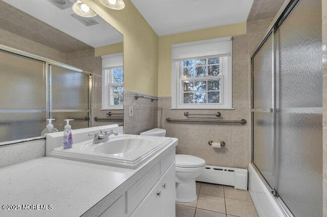 full bath with tile walls, a baseboard radiator, toilet, tile patterned floors, and vanity