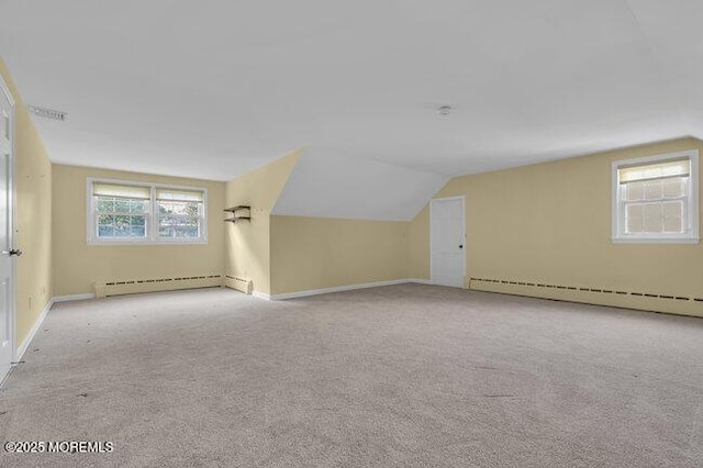 bonus room featuring baseboards, carpet flooring, vaulted ceiling, and a baseboard radiator