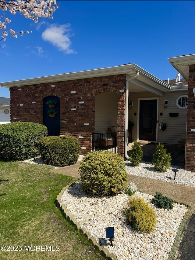 property entrance featuring brick siding