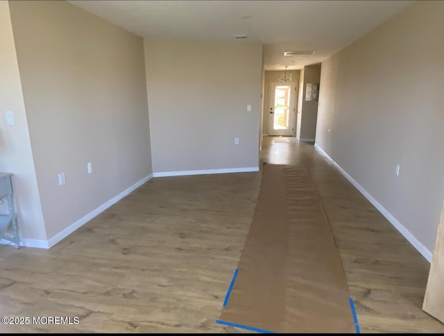 interior space featuring wood finished floors and baseboards