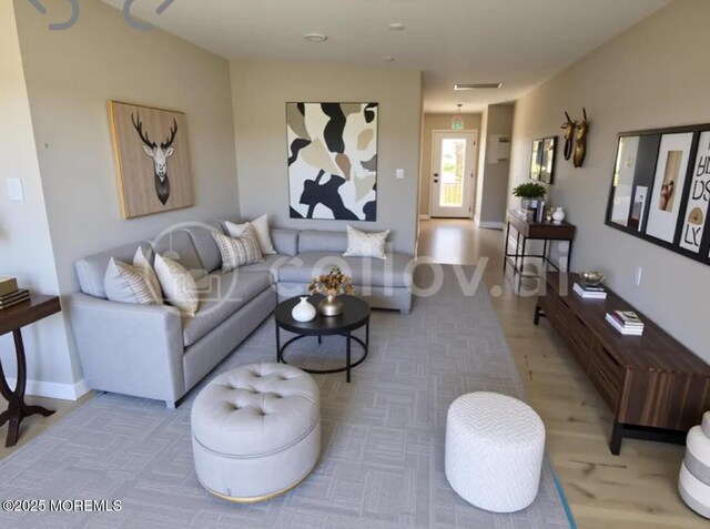 living area featuring baseboards