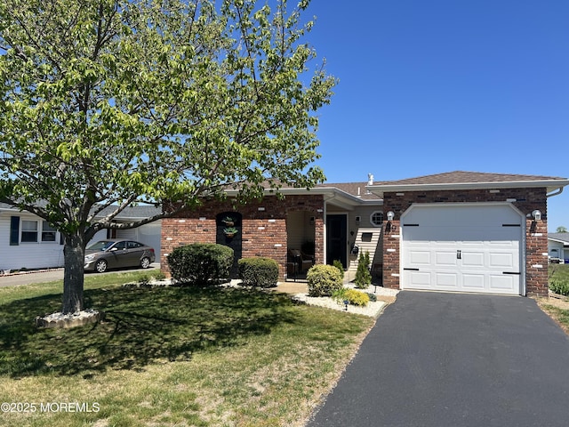 view of front facade with brick siding, aphalt driveway, a front yard, and an attached garage