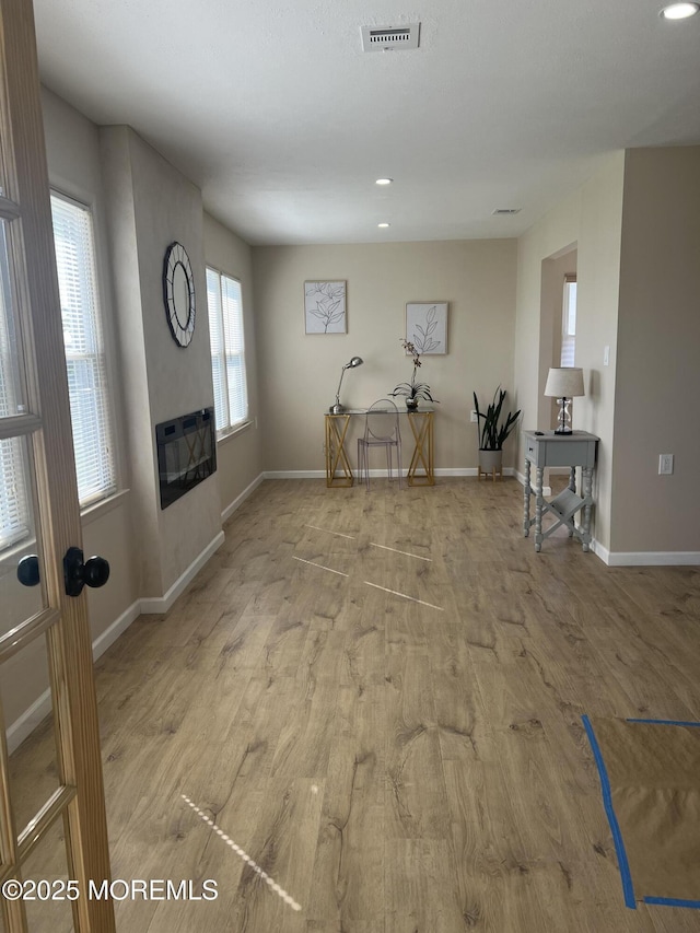49 Watkins Rd, Brick, NJ 08724 - living area with wood finished floors, a glass covered fireplace, baseboards, recessed lighting, and heating unit