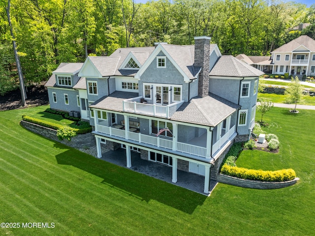 11 Beacon Hill Rd, Atlantic Highlands, NJ 07716 - back of property featuring a balcony, a chimney, a shingled roof, and a yard