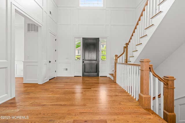 11 Beacon Hill Rd, Atlantic Highlands, NJ 07716 - entrance foyer with a decorative wall, light wood-style flooring, and stairway
