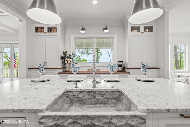 11 Beacon Hill Rd, Atlantic Highlands, NJ 07716 - kitchen with white cabinets, a sink, light stone countertops, ornamental molding, and recessed lighting