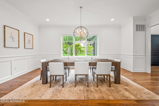 11 Beacon Hill Rd, Atlantic Highlands, NJ 07716 - dining room featuring a chandelier, a decorative wall, crown molding, wood finished floors, and recessed lighting