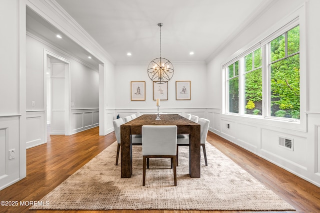 11 Beacon Hill Rd, Atlantic Highlands, NJ 07716 - dining room featuring a chandelier, ornamental molding, a decorative wall, wood finished floors, and recessed lighting