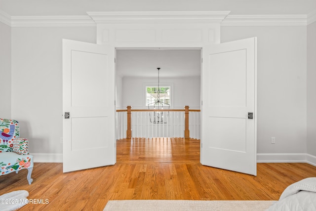 11 Beacon Hill Rd, Atlantic Highlands, NJ 07716 - hall featuring crown molding, wood finished floors, baseboards, a chandelier, and an upstairs landing