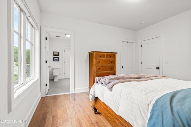 11 Beacon Hill Rd, Atlantic Highlands, NJ 07716 - bedroom featuring multiple windows, light wood-type flooring, baseboards, and connected bathroom