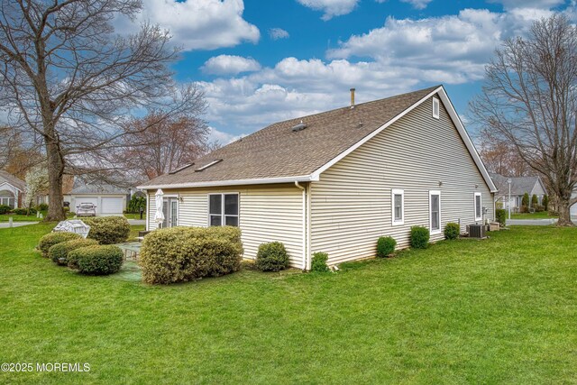 1792 Buttonwood Ave, Toms River, NJ 08755 - view of side of home with central AC unit, an outdoor structure, a shingled roof, and a lawn