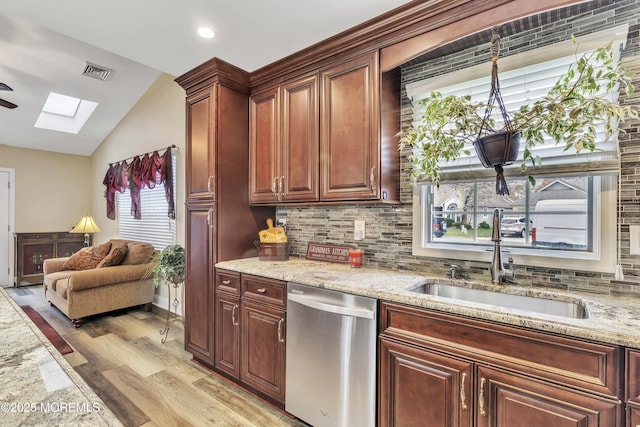 1792 Buttonwood Ave, Toms River, NJ 08755 - kitchen with light stone countertops, visible vents, lofted ceiling with skylight, dishwasher, and a sink