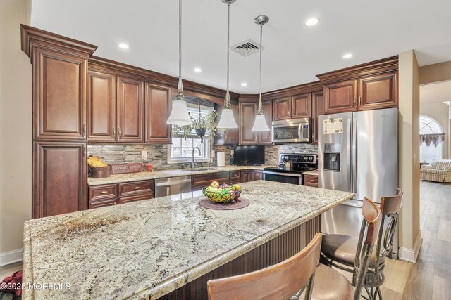 1792 Buttonwood Ave, Toms River, NJ 08755 - kitchen featuring light wood-style floors, visible vents, a healthy amount of sunlight, stainless steel appliances, and baseboards