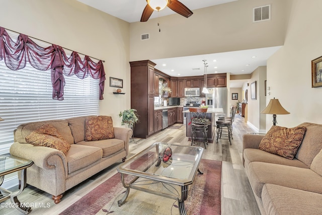 1792 Buttonwood Ave, Toms River, NJ 08755 - living area featuring visible vents, ceiling fan, a high ceiling, and light wood-style flooring