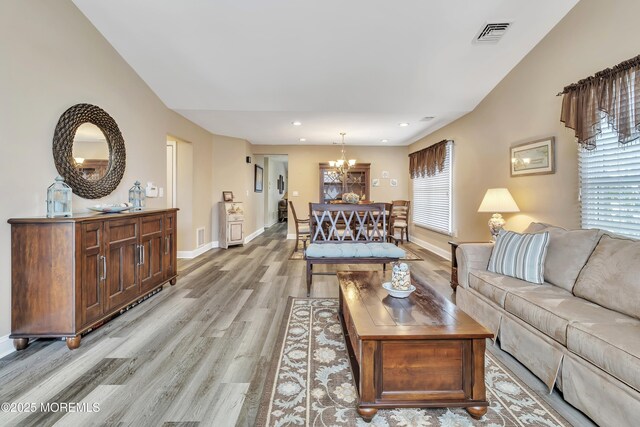 1792 Buttonwood Ave, Toms River, NJ 08755 - living area with visible vents, light wood finished floors, a chandelier, and a healthy amount of sunlight