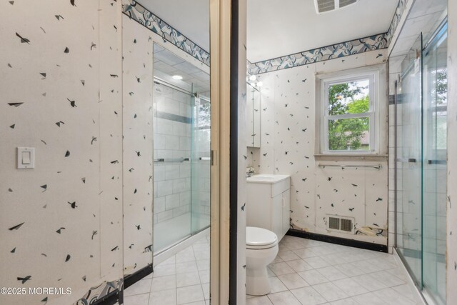 full bath featuring wallpapered walls, vanity, a stall shower, toilet, and tile patterned floors