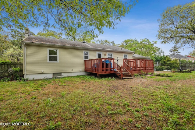 rear view of property with a deck and a chimney