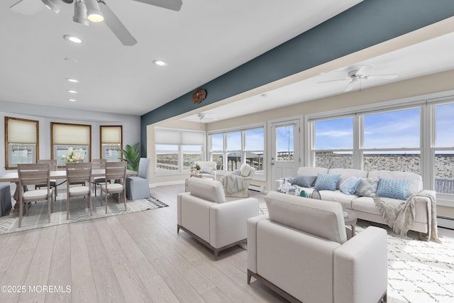 living room featuring a ceiling fan, light wood finished floors, and recessed lighting