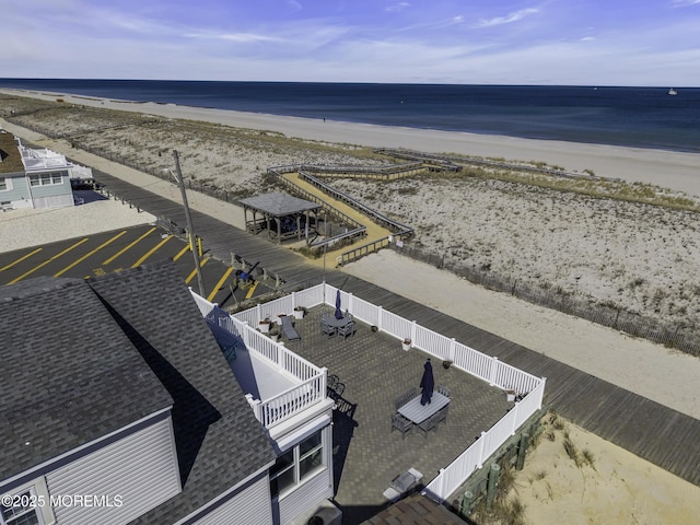 birds eye view of property with a beach view and a water view