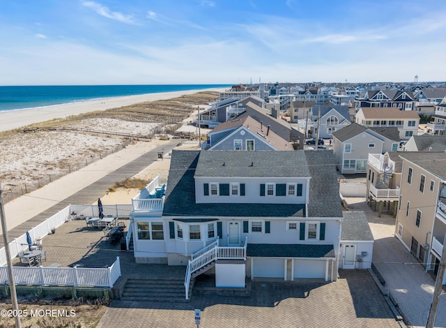 birds eye view of property with a beach view and a water view
