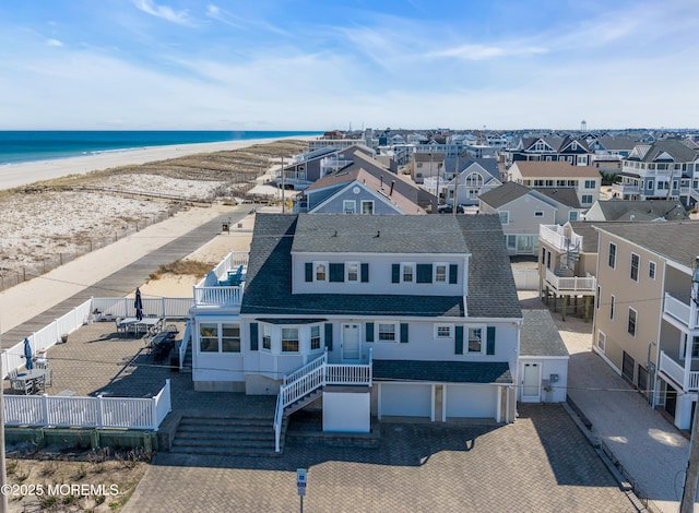birds eye view of property with a beach view, a residential view, and a water view