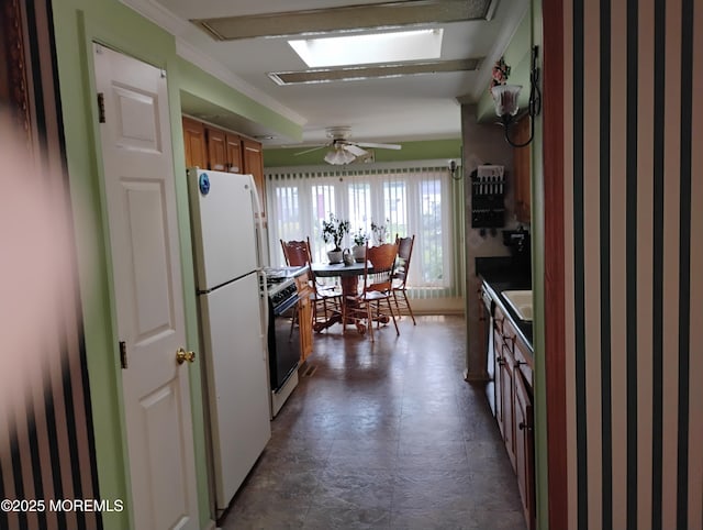 53 Pine Ridge Blvd, Whiting, NJ 08759 - kitchen featuring freestanding refrigerator, black stove, brown cabinets, ornamental molding, and a ceiling fan