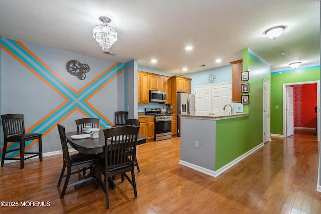 439 Sophee Ln, Lakewood, NJ 08701 - dining area with recessed lighting, light wood-type flooring, baseboards, visible vents, and a notable chandelier
