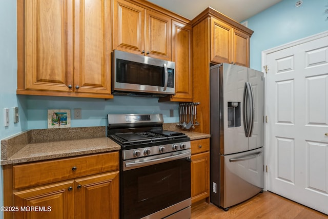 439 Sophee Ln, Lakewood, NJ 08701 - kitchen featuring appliances with stainless steel finishes, brown cabinetry, and light wood-type flooring
