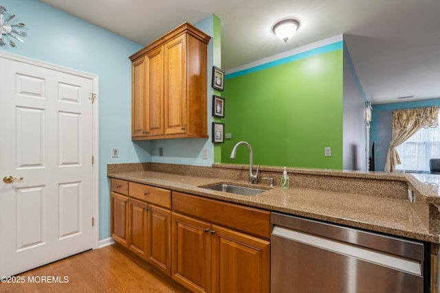 439 Sophee Ln, Lakewood, NJ 08701 - kitchen featuring stainless steel dishwasher, a sink, stone countertops, light wood finished floors, and brown cabinetry