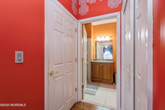 439 Sophee Ln, Lakewood, NJ 08701 - hallway featuring light tile patterned floors and a sink