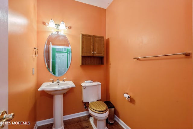 439 Sophee Ln, Lakewood, NJ 08701 - half bath featuring baseboards, wood finished floors, toilet, and a sink