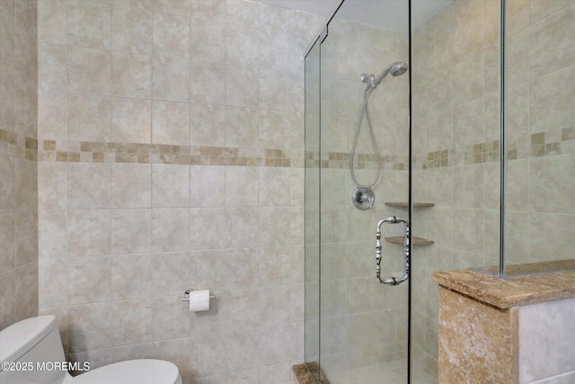 full bathroom featuring a tile shower and toilet
