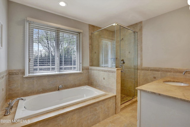 bathroom featuring a shower stall, a bath, tile patterned floors, and tile walls