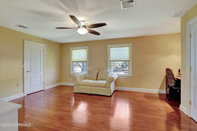 living area with ceiling fan, wood-type flooring, and visible vents