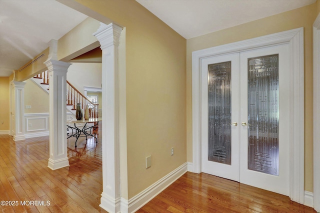 doorway to outside with stairway, wood-type flooring, and french doors